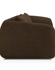 Side view of a modern, low-profile Figur Sofa | 3 Seater by Ethnicraft, showcasing dark brown fabric with rounded edges and a plush, cushioned design—an ideal choice for contemporary living against a white background.
