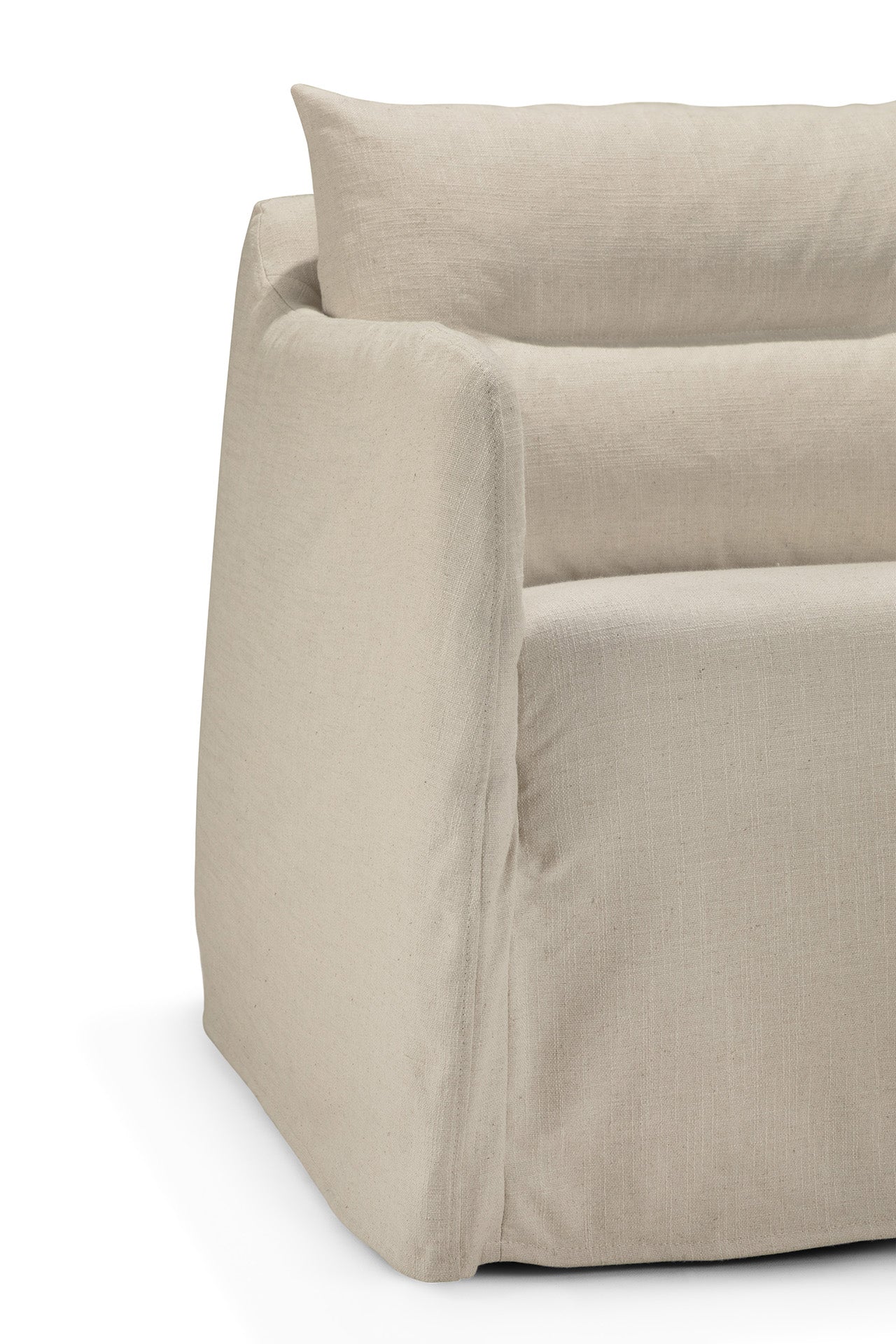 A close-up of the left side of the Weave Lounge Chair - Bone by Ethnicraft shows its boxy, modern design and plush backrest cushion. The soft, textured upholstery resembles a slipcover, highlighting the chair’s stylish comfort.