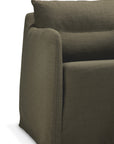 A close-up of the Ethnicraft Weave Lounge Chair - Green, featuring olive green upholstery, a soft cushioned back, and rounded armrests, set against a plain white background.