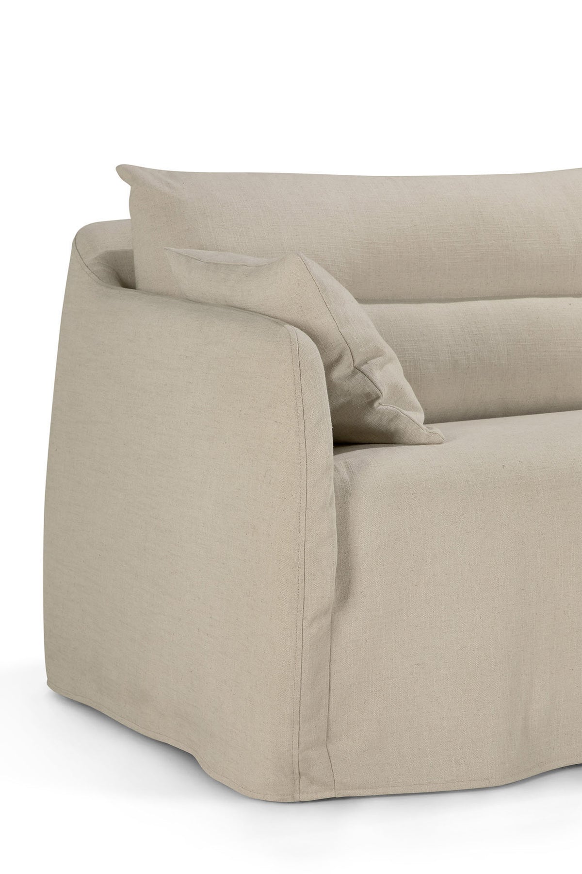 A close-up of the Ethnicraft Weave sofa | 2 Seater Bone showcases its light beige, soft linen-blend upholstery and two matching cushions. Designed with rounded edges and a relaxed, removable slipcover, the sofa reflects Ethnicraft’s timeless aesthetic. Only part of the left side and seat are visible against a white background.