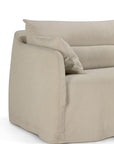 A close-up of the Ethnicraft Weave sofa | 2 Seater Bone showcases its light beige, soft linen-blend upholstery and two matching cushions. Designed with rounded edges and a relaxed, removable slipcover, the sofa reflects Ethnicraft’s timeless aesthetic. Only part of the left side and seat are visible against a white background.