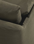 Close-up of the Ethnicraft Weave Sofa | 2 Seater Green, highlighting the armrest, seat, and backrest cushion with visible fabric texture and detailed stitching.