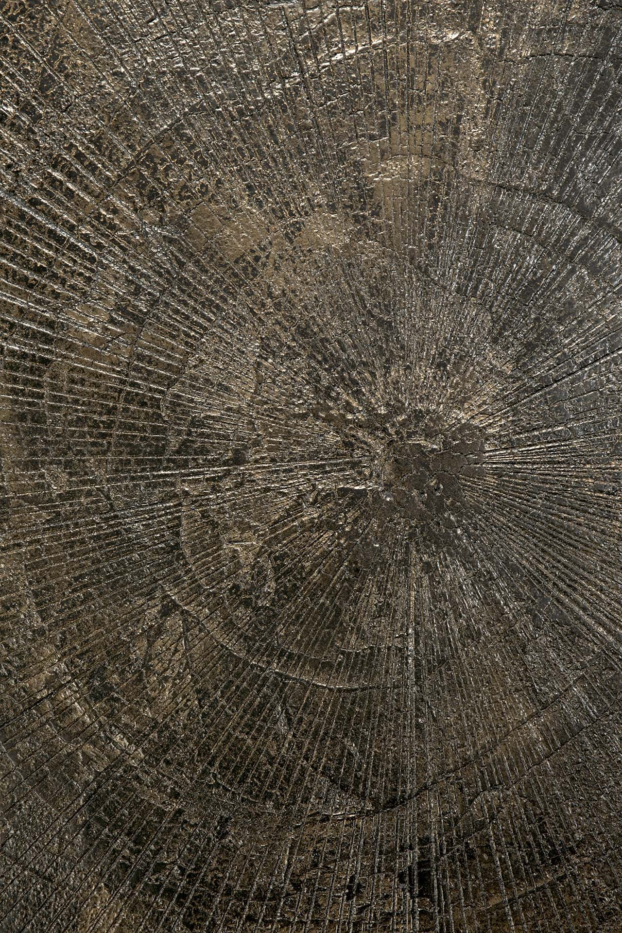 Close-up of the Blend Dining Table - Ray Whisky by Ethnicraft shows a textured metallic surface with circular, sunburst-like patterns in bronze, gold, and dark brown—perfect for interchangeable table tops in commercial spaces.