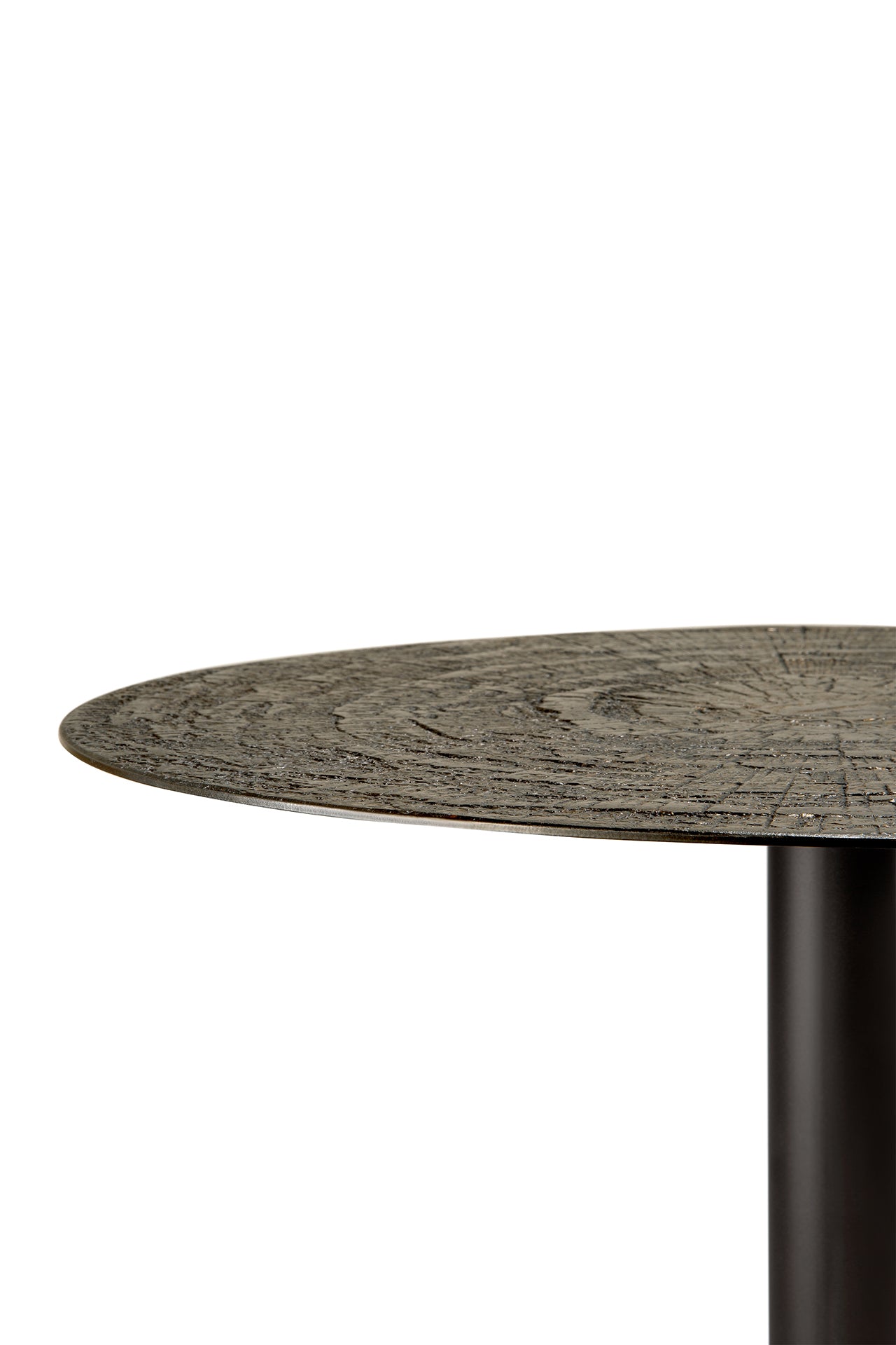 A close-up of the Ethnicraft Blend Dining Table - Ray Whisky shows its round, textured wooden top with visible grain and a dark cylindrical metal leg—ideal for commercial settings, set against a white background.