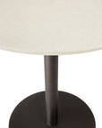 The Ethnicraft Blend Dining Table - Microcement features a round, light-textured tabletop and a black cylindrical pedestal on a circular black metal base, displayed against a white background.