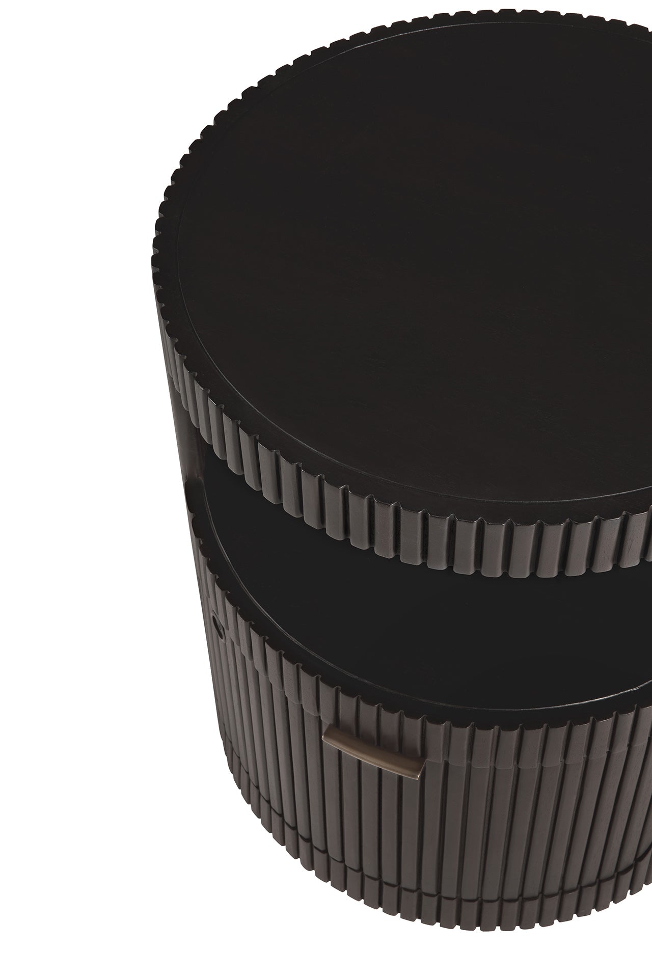 The image shows the Ethnicraft Boomerang Drawer Unit, a round, dark brown mahogany side table with a ridged surface, an open middle shelf, and a small handle on the lower section. The photo is taken from an overhead angle.