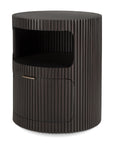 The Ethnicraft Boomerang Drawer Unit is a round, modern nightstand featuring dark brown stained mahogany, vertical groove texture, an open shelf, and a lower cabinet with a sleek metal handle.