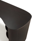 The Ethnicraft Roller Max Desk, shown overhead against a white background, features dark mahogany wood, a curved asymmetrical top, and vertical slatted sides.