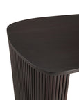 Close-up of the Ethnicraft Roller Max Desk featuring dark wood, a rounded edge, and vertically grooved legs, set against a white background.