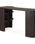 The Ethnicraft Roller Max Desk is a modern, minimalist desk with a curved top, two rounded fluted legs, and two open shelves on the left for storage.