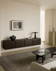 Wall-mounted Ethnicraft PI Light Hanging Sideboard with four cabinet doors, featuring a black vase, small decorative objects, and a table lamp on top.