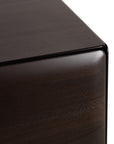 Close-up of the rounded corner of an Ethnicraft PI Light Hanging Sideboard, showcasing its rich mahogany wood grain.