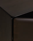 Close-up view of the corner of a dark mahogany PI Light Hanging Sideboard by Ethnicraft with a partially opened door.