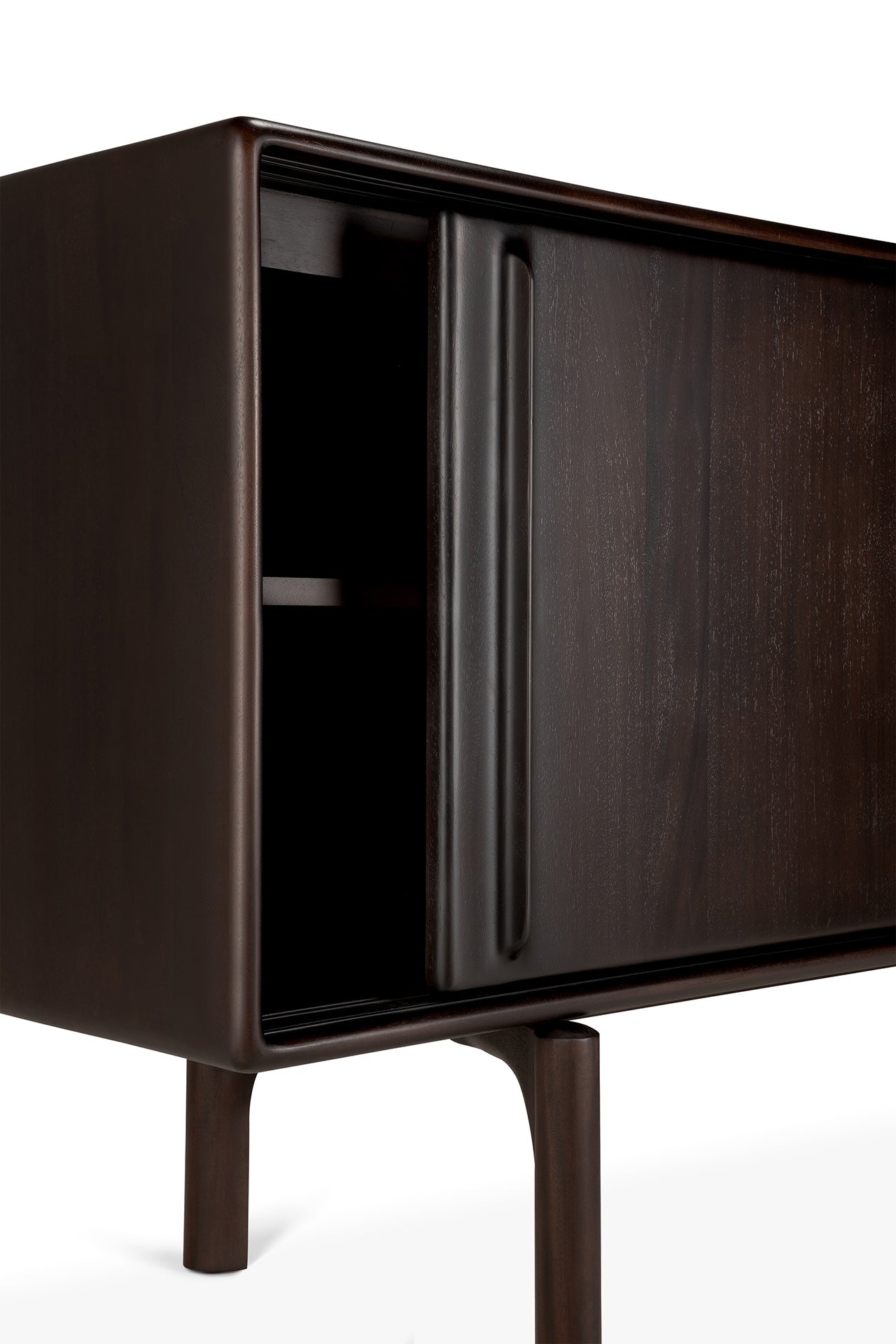 A close-up of the Ethnicraft Flow Sideboard shows its modern dark wood design with rounded edges, slim legs, and an open sliding door revealing partially visible interior shelves, set against a white background.