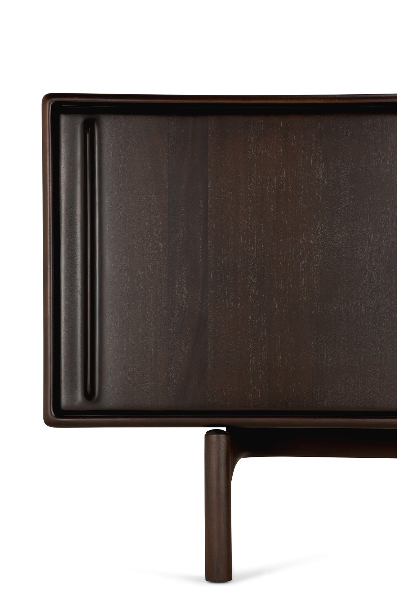 Close-up of the Flow Sideboard by Ethnicraft, featuring dark mahogany, a smooth rectangular surface with rounded edges, and a single cylindrical leg—blending sleek minimalism and vintage modern style.