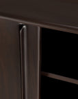 Close-up of the Flow Sideboard by Ethnicraft in dark brown mahogany, highlighting a smooth corner edge, part of the door, and interior shelf. The polished surface emphasizes its vintage modern design and refined craftsmanship.