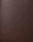 Close-up of the burgundy leather grain texture on a Jack Lounge Chair - Burgundy Leather by Ethnicraft.