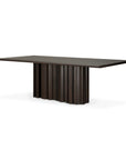 The Sequence Dining Table by Ethnicraft showcases a modern rectangular design with a dark brown mahogany top and sculptural, wavy vertical base panels for a striking architectural style.