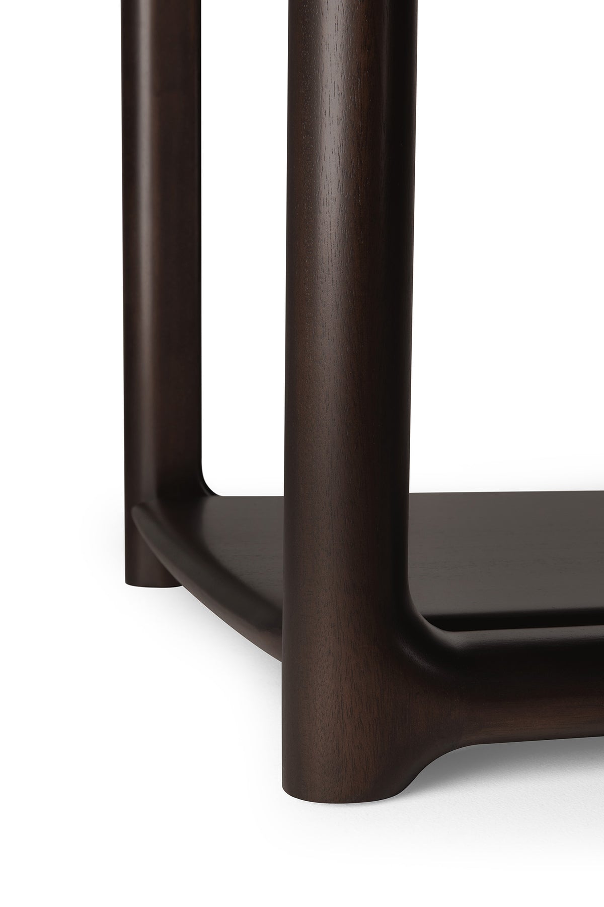 Close-up of a mahogany Ethnicraft Eda Side Table with rounded legs and a lower shelf.