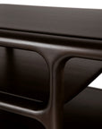 Close-up of the Eda Coffee Table by Ethnicraft—a modern piece crafted in rich, dark wood with smooth, rounded edges and an integrated lower shelf, set against a white background—showcasing heirloom-quality furniture inspired by European craftsmanship.
