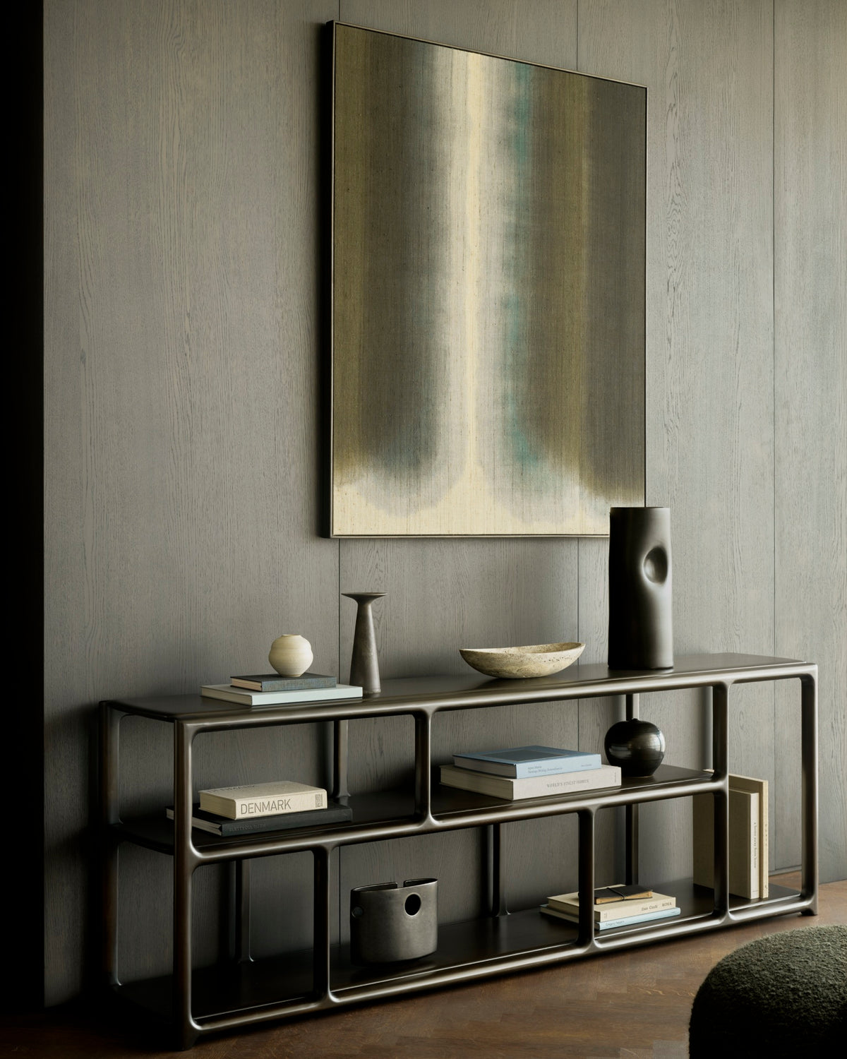 An heirloom-quality Ethnicraft Eda Console | Wide holding books, a bowl, and decorative vases, positioned below a large abstract wall painting.