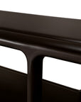Close-up of a dark brown Eda Console | Wide showing the curved edge of the top surface and a rounded support leg.