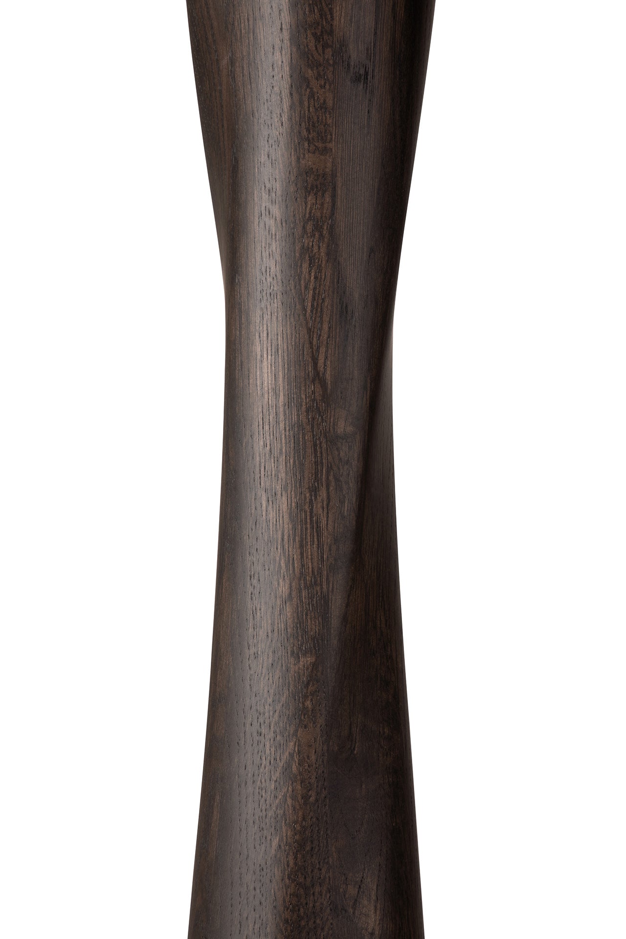 A close-up of the Ethnicraft Torsion Dining Table in Oak Brown highlights its smooth, hourglass-shaped design and elegant natural oak grain, showcasing the table’s refined craftsmanship and rich texture.