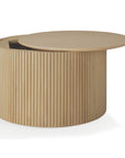 The Ethnicraft Roller Max Coffee Table – Oak features a modern, minimalist design with vertical slats, a partially open sliding top for hidden storage, and a light solid oak finish.