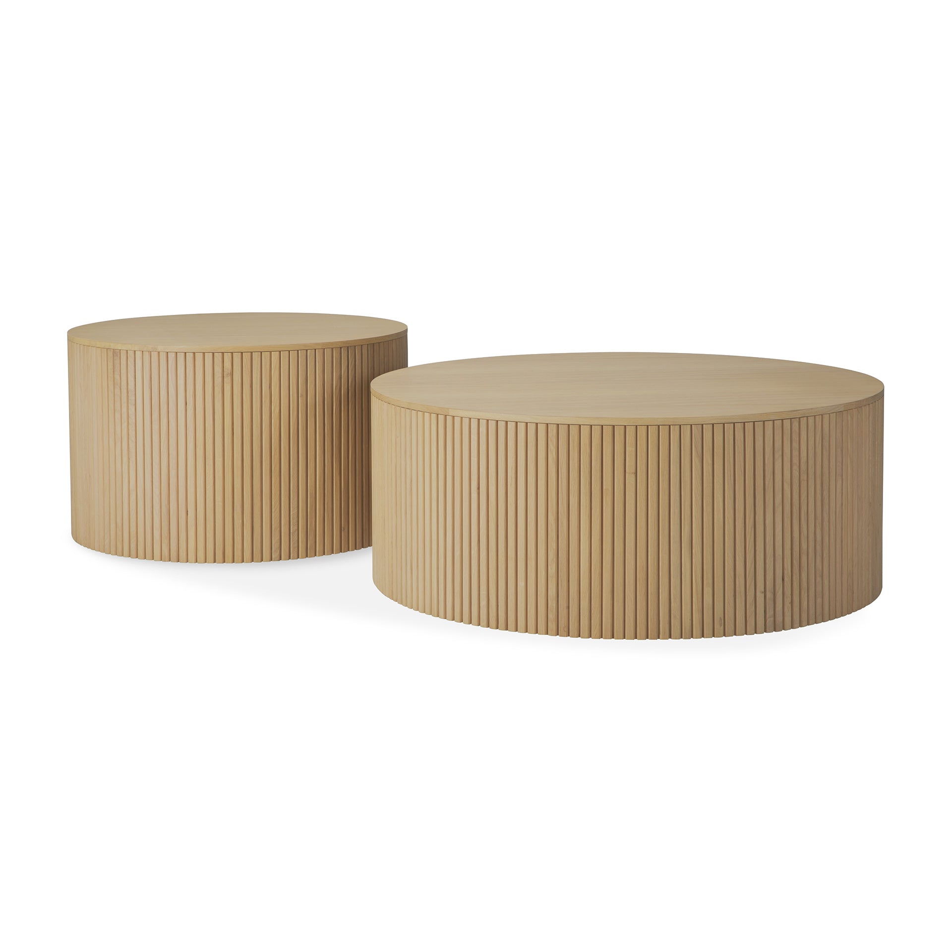 The Roller Max Coffee Tables by Ethnicraft are crafted from solid oak, featuring round shapes, vertical side grooves, and a smooth finish—one taller and smaller, the other wider and lower—for a modern minimalist look.