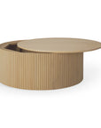 The Roller Max Coffee Table - Oak by Ethnicraft is a round, solid oak coffee table with vertical grooves and a lift-top lid revealing hidden storage—modern, stylish, and functional for any living space.