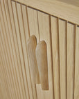 Close-up of the Ethnicraft Roller Max Sideboard in light wood, showcasing vertical slats, two matching wooden handles, and a natural solid oak texture with clean modern lines.