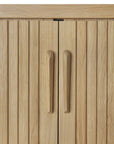 Close-up of two vertical wooden cabinet doors with grooved panels and matching handles in light-toned wood, featured on the Ethnicraft Roller Max Sideboard.