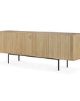 The Ethnicraft Roller Max Sideboard showcases vertical grooved doors, a light natural finish, and slim black metal legs for a modern look.