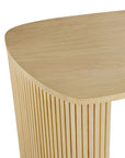 A close-up of the Ethnicraft Roller Max Desk | Oak displays its smooth, rounded top and vertical slatted paneling along the side, crafted from light oak wood.