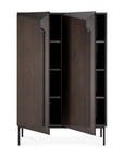 The Ethnicraft Stairs cupboard - Oak Brown features a modern, geometric design in dark solid oak with push-to-open doors, interior shelves, and stands on four slim black metal legs.
