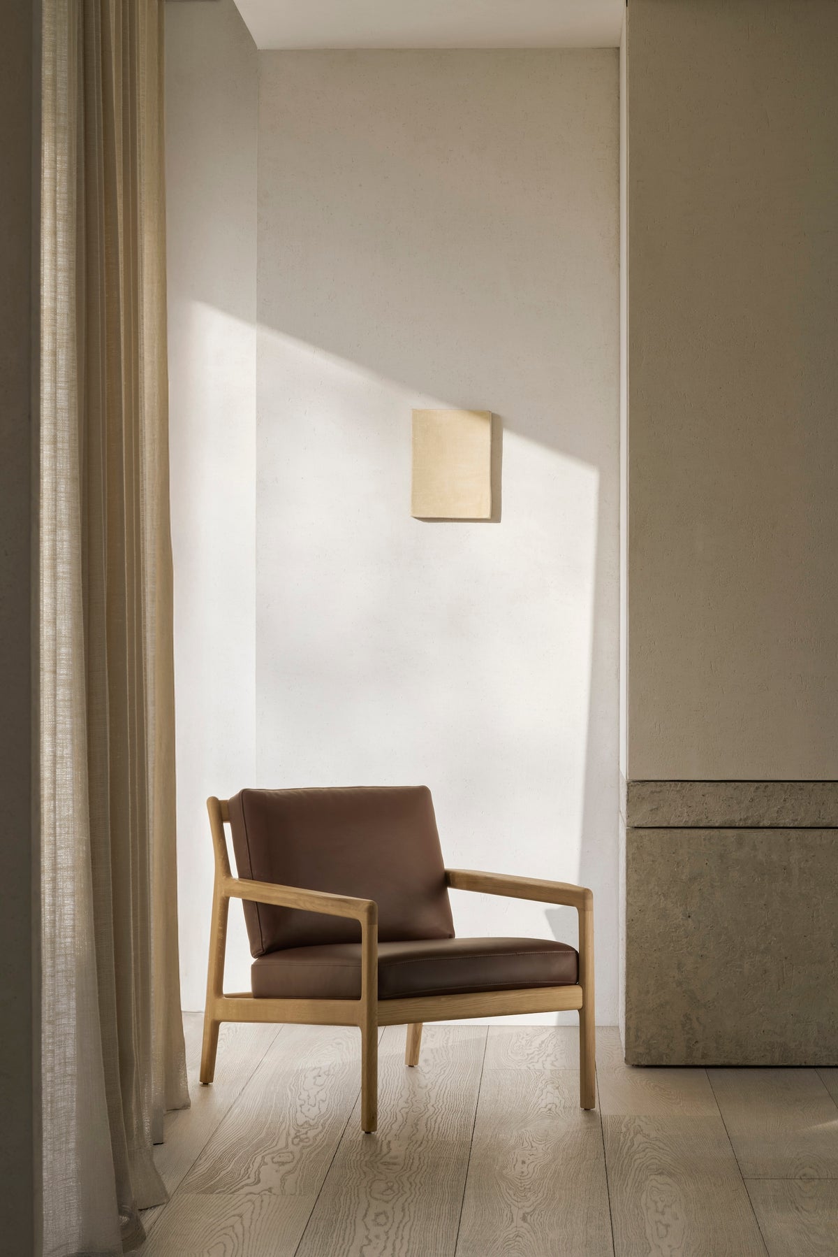 An Ethnicraft Jack Lounge Chair - Burgundy Leather in solid oak with dark brown leather cushions in a Scandinavian style.