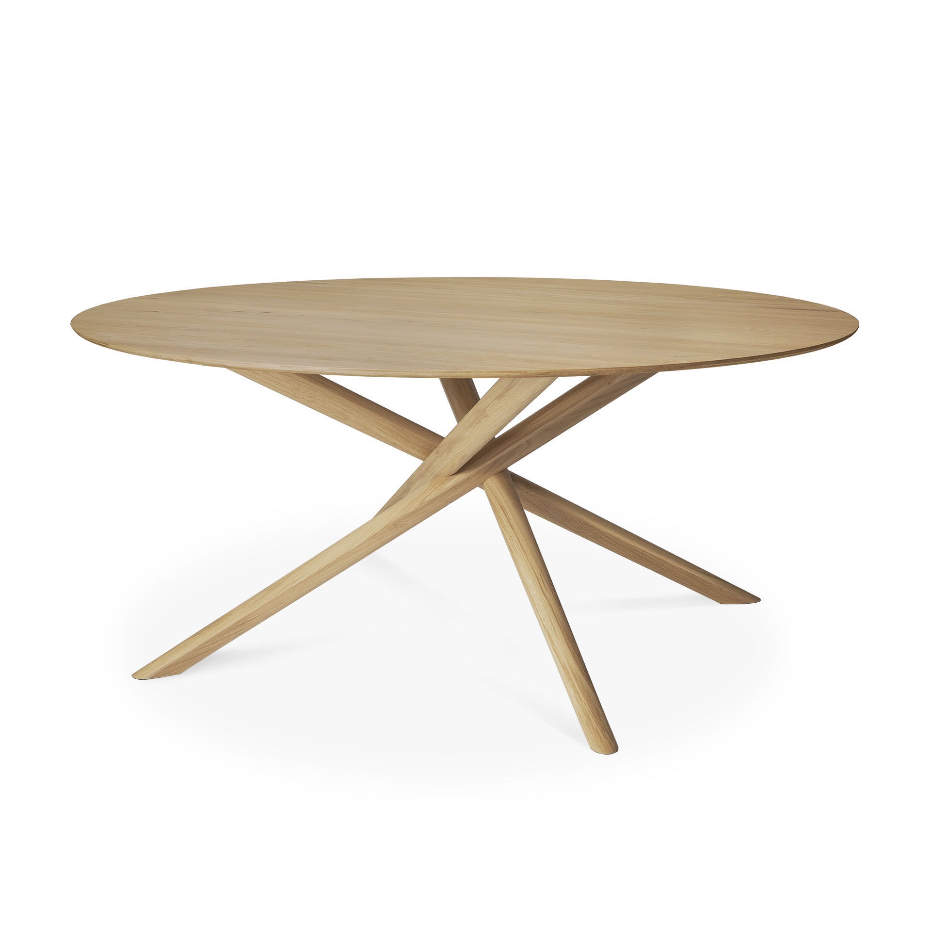 The Mikado Dining Table Round - Oak by Ethnicraft features a solid oak build with a smooth top and three angled legs meeting at the center, embodying modern minimalist design.