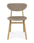The Ethnicraft Eye Dining Chair features solid oak legs and frame, a rounded upholstered backrest, and a cushioned seat in warm grey fabric.