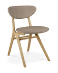 The Ethnicraft Eye Dining Chair features solid European oak, angled legs, and a modern minimalist design, with a warm grey fabric-upholstered seat and backrest.