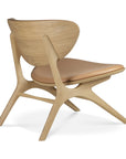 The Ethnicraft Eye Lounge Chair - Oak with Leather features a sculpted curved backrest, Sienna leather seat cushion, and angled legs, blending solid oak craftsmanship with smooth contemporary lines.