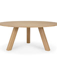 Round solid oak Unda Dining Table by Ethnicraft, featuring three thick, angled legs.