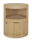 The Ethnicraft Boomerang Drawer Unit - Oak features a round, solid oak design with vertical grooves, an open shelf, and a lower cabinet with handle and lock—reflecting modern minimalism.