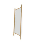 The Ethnicraft PI Floor Mirror – Oak features a tall, rectangular design with a rounded solid oak frame and legs, a polished imperfect finish, and stands upright at a slight angle against a white background.