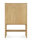 The Ethnicraft PI Cupboard - Oak is a tall, light wood cupboard with two doors, a minimalist design, an open lower shelf, and four legs, shown against a plain white background.