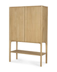 The Ethnicraft PI Cupboard - Oak is a tall, minimalist cabinet crafted from solid oak, featuring two doors, an open lower shelf, and four legs—a modern storage solution for any space.