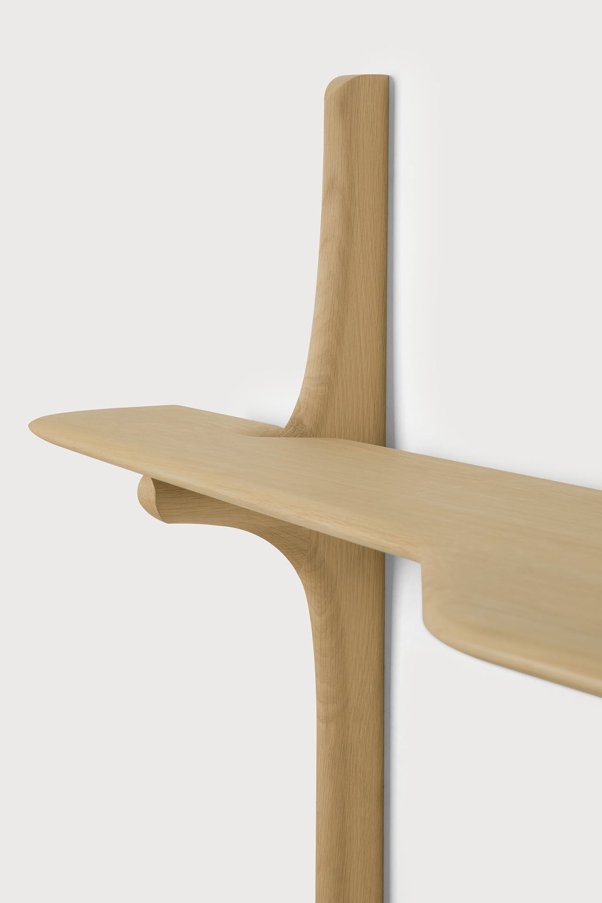 Ethnicraft PI Wall Mounted Desk, a solid oak shelf with a curved, organic design supported by a central vertical pillar.