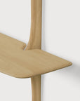 An Ethnicraft PI Wall Mounted Desk featuring a solid oak, rounded tabletop attached to a vertical support.