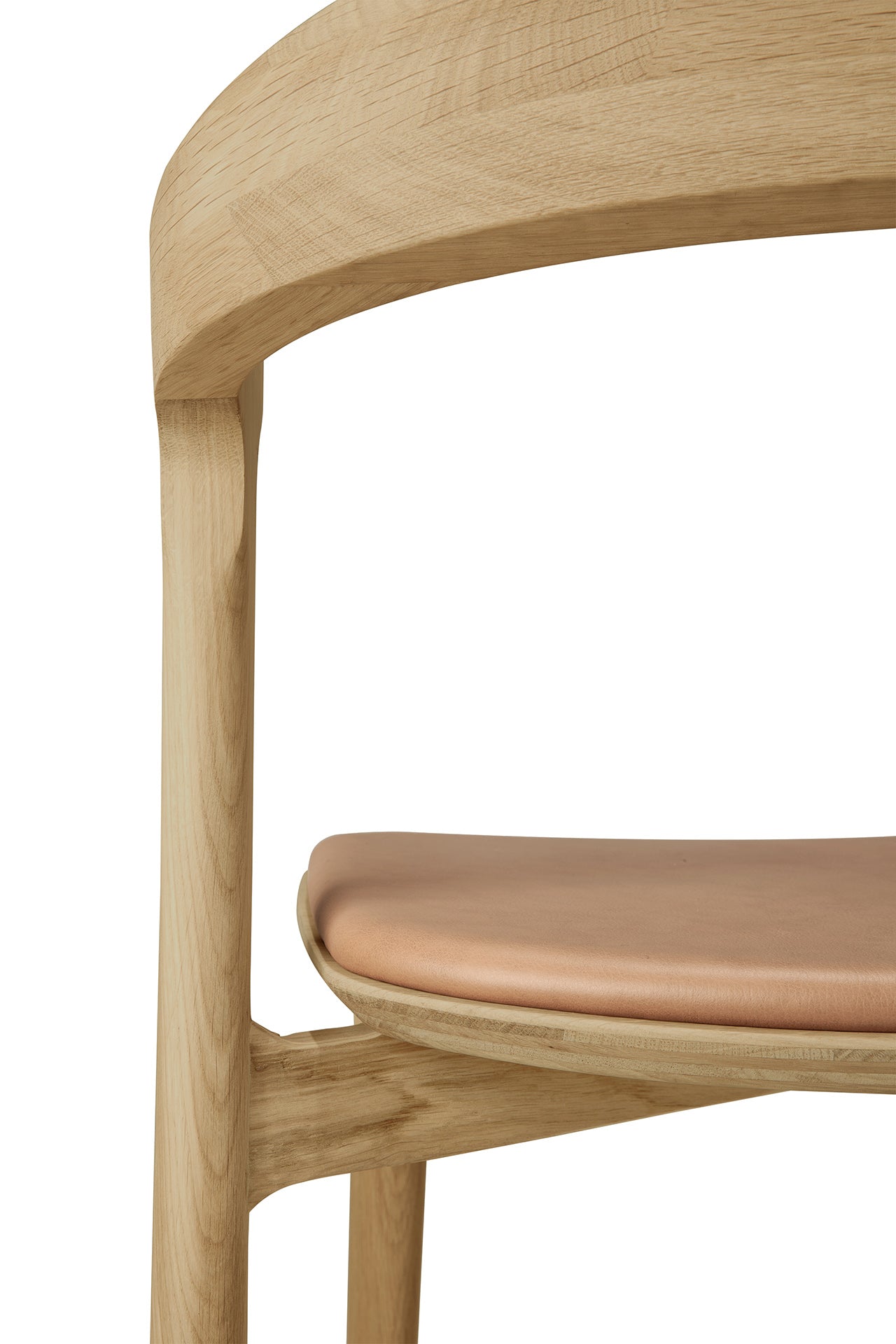 Close-up of the Ethnicraft Bok Dining Chair - Oak with Sienna Leather, highlighting its smooth solid oak frame and sienna leather seat cushion against a plain white background.