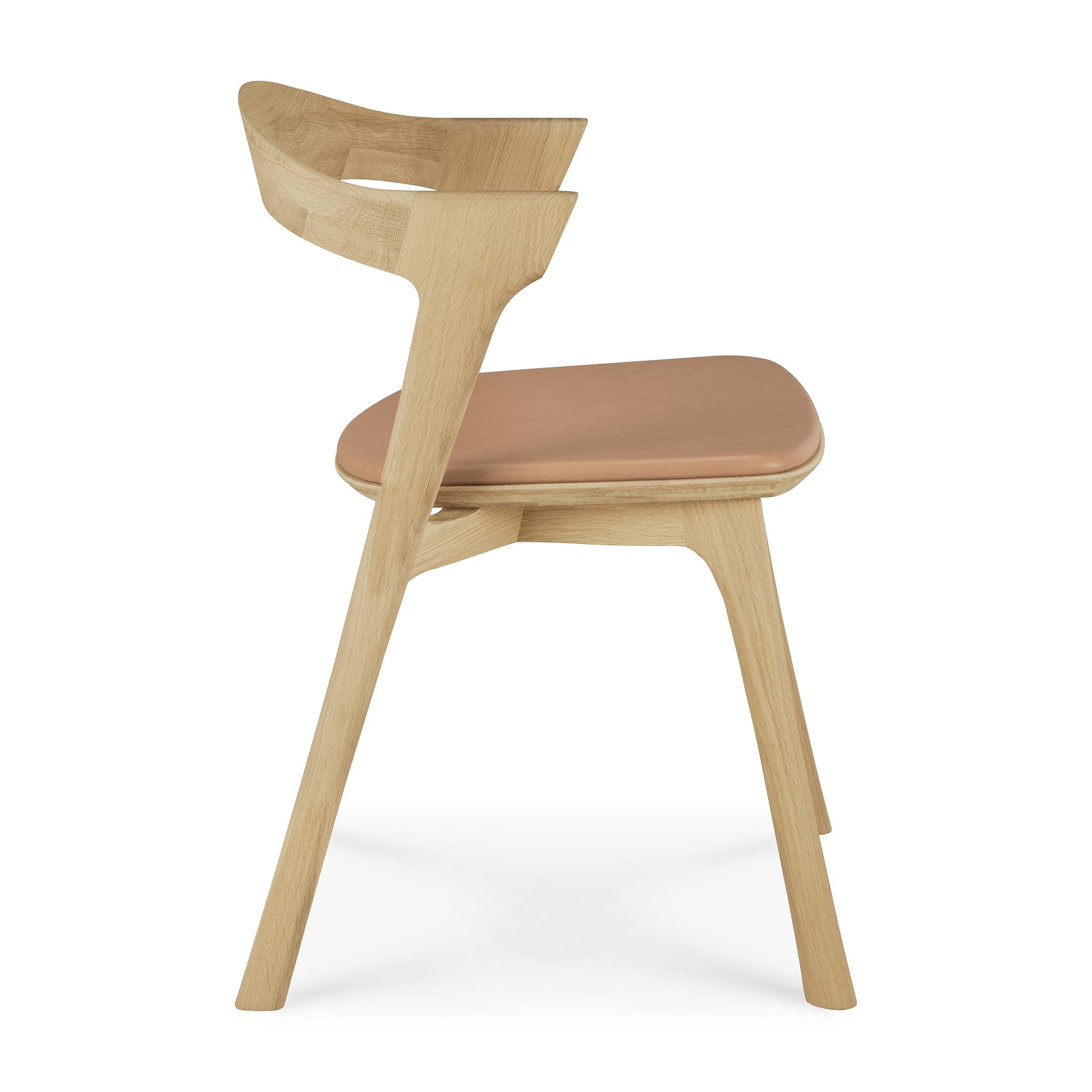 Side view of the Ethnicraft Bok Dining Chair, crafted from solid oak with a curved backrest and sienna leather seat. The chair boasts clean, minimalist lines and a natural wood finish.