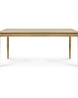 The Ethnicraft Bok Dining Table - Oak is a rectangular solid oak table with four straight legs, featuring a simple, minimalist design, shown against a white background.